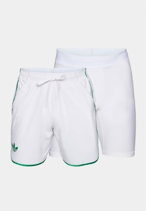 White athletic shorts with green trim and an elastic waistband, paired with white tight-fitting shorts underneath.