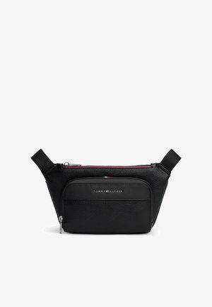 Banane en cuir noir Tommy Hilfiger avec poche zippée à l'avant et sangles latérales réglables sur fond blanc.