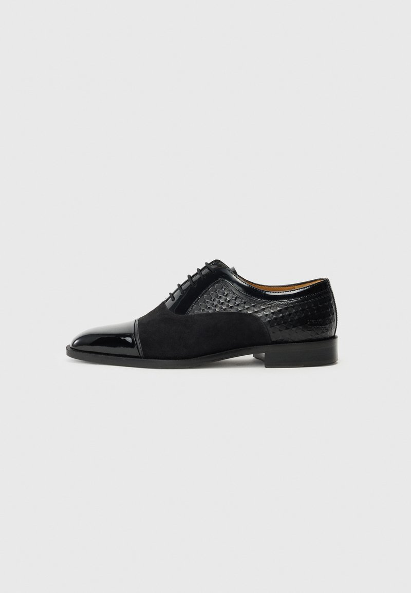 Black formal shoes featuring a combination of shiny patent leather and textured suede, with a rounded toe and a low heel.