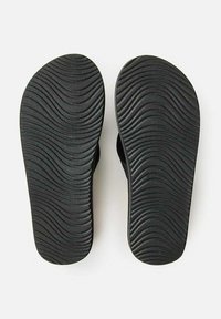 Black sandals with a textured wavy sole. Features a smooth finish and open design, allowing for breathability and comfort.