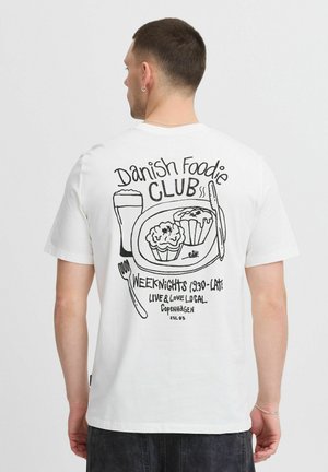 White cotton t-shirt featuring a black graphic print on the back with food items, cutlery, and text. Crew neck and short sleeves.