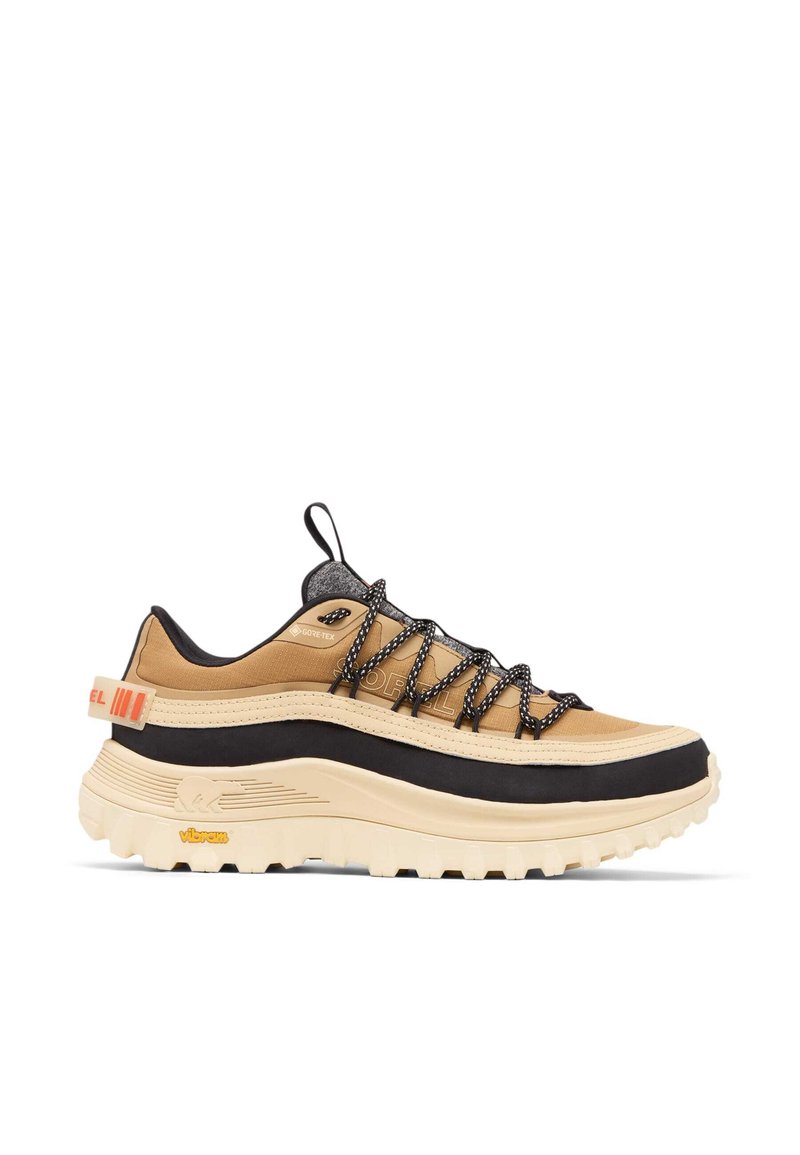 Chaussure de sport beige et noire avec une tige texturée, des lacets noirs et une semelle blanche épaisse. Comprend une languette de tirage et le logo "Gore-Tex".
