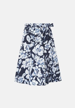 Jupe portefeuille bleu marine avec motif floral blanc et lien à nouer sur le côté à la taille.