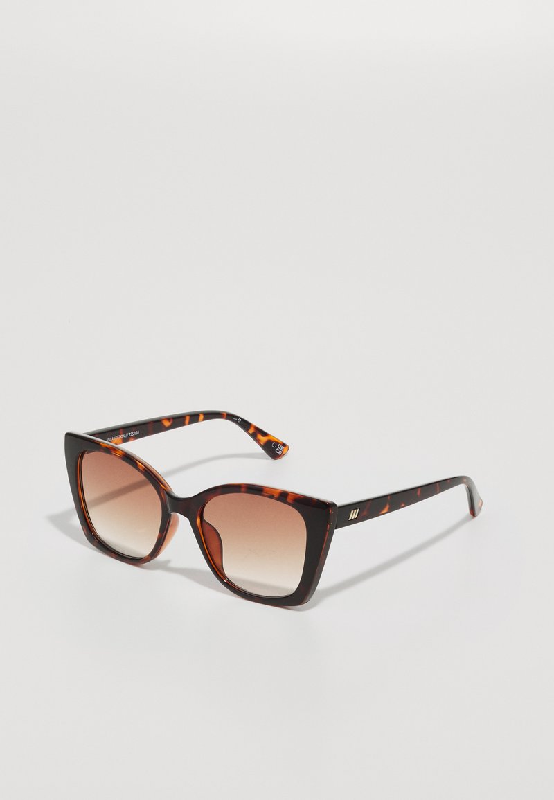 Tortoiseshell sunglasses with oversized square lenses, gradient brown tint, and sleek, glossy arms featuring subtle metallic accents.