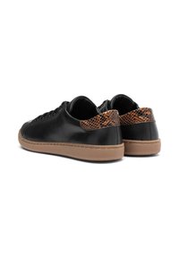 Black leather sneakers featuring a textured brown snake-patterned back, tan rubber sole, and traditional lace-up design.
