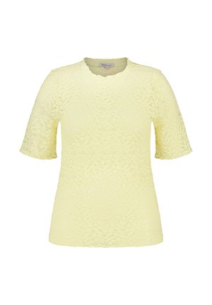 Lichtgele kanten blouse met korte mouwen, met gegolfde ronde halslijn en bloemenpatroon, maat medium.