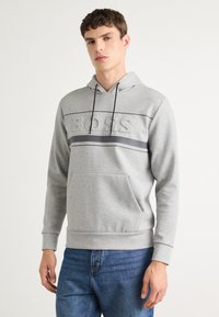 Light gray hoodie featuring a textured "BOSS" logo, horizontal stripes, adjustable drawstring, and a front kangaroo pocket.