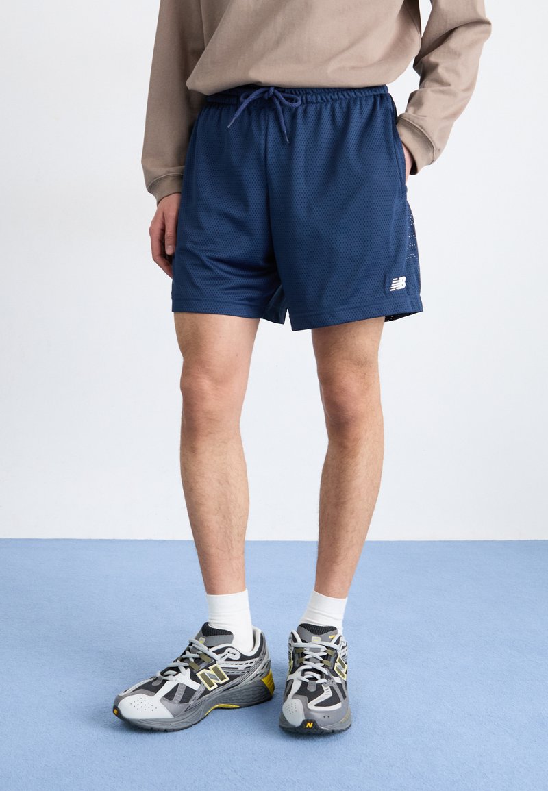 New Balance ESSENTIALS - Tracksuit bottoms - navy/dark blue - Zalando.ie