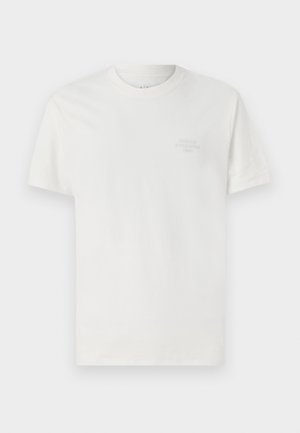 T-shirt en coton blanc à manches courtes, col rond, avec le logo embossé "Armani Exchange 1991" sur la poitrine. Texture lisse, coupe classique.