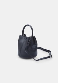 Navy leather bucket bag with rounded shape, top handles, adjustable shoulder strap, and smooth texture; features a minimalistic design.
