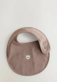 Brown ribbed bib with a round shape and a looped neckline. Features a small embroidered bear face and two snap-button closures.