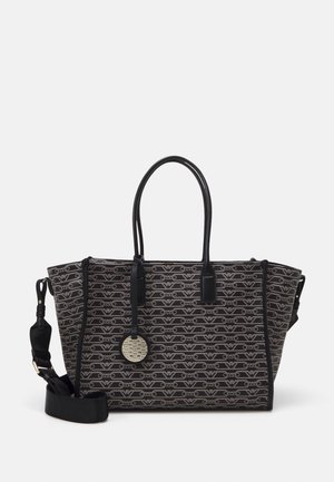 Black and gray patterned tote bag with double handles, detachable shoulder strap, and round metallic logo tag hanging from one handle.