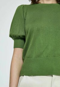 Maglione verde lavorato a maglia con maniche a sbuffo corte, polsini a costine e orlo a costine, che presenta una texture liscia e un colore solido.