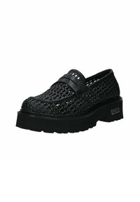 Chaussure slip-on tissée noire avec une semelle plateforme épaisse, présentant une bande d'accent lisse sur le dessus et un design ouvert pour la respirabilité.