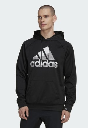 Felpa nera con cappuccio caratterizzata da un grande logo Adidas bianco con un design screziato. Ha una tasca a marsupio e un cappuccio regolabile con polsini a coste.