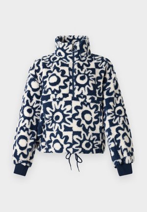 Fleeces kreklis ar tumši zilu un baltu abstraktu ziedu rakstu, pusklača priekšpusi, augstu apkakli, elastīgām aprocēm un sašaurināmu apakšmalu.