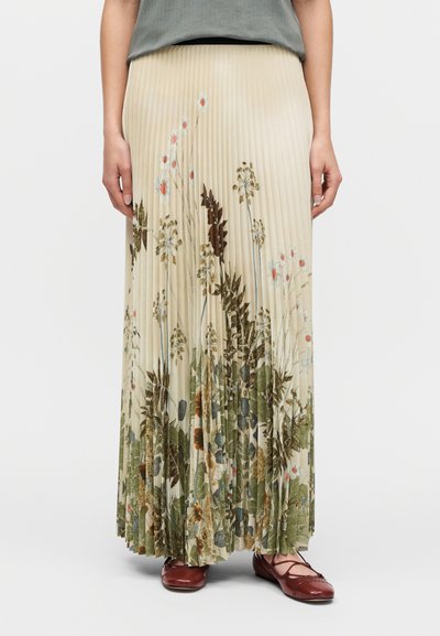 Πλισέ, φούστα μακριά μέχρι το πάτωμα σε ανοιχτό μπεζ χρώμα με λουλουδάτο σχέδιο σε πράσινους και παστέλ τόνους. Διαθέτει ζώνη στη μέση και απαλό ύφασμα.