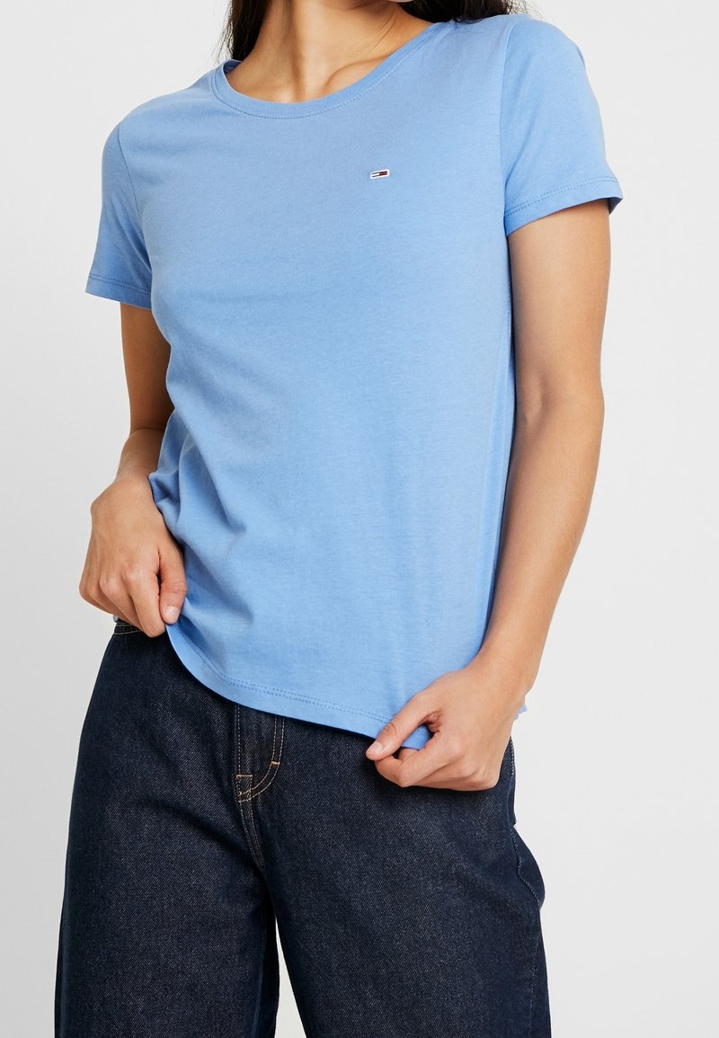 Light blue short-sleeve t-shirt made of soft cotton fabric, featuring a small logo on the chest and a round neckline.