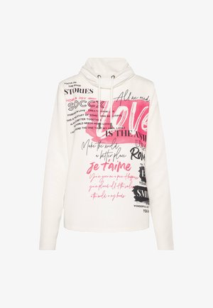 White hoodie with a high collar and drawstrings. Features multicolored printed text and graphics in various fonts, including pink and black accents.