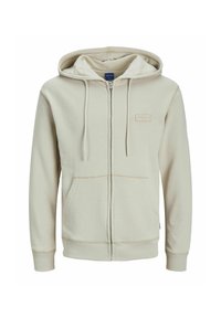 Beige lukkable kapuutsiga dressipluus, millel on nööriga kapuuts, ees taskud ja tekstureeritud kangas. Esiküljel vasakul rinnapiiril on väike silt.