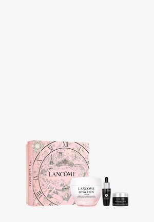 Barattolo di crema Lancôme Hydra Zen, scatola rosa con design di quadrante d'orologio, accenti in bianco e nero, include siero e crema per gli occhi in un elegante packaging nero.