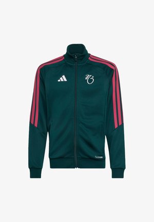 Ciemnozielona kurtka dresowa Adidas z różowymi paskami na rękawach, pełnym zamkiem błyskawicznym z przodu oraz białymi logo na piersi i dole.