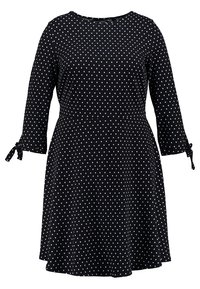Černé šaty s bílými puntíky, tříčtvrtečními rukávy, kulatým výstřihem a zavazováním na koncích rukávů. Rozšířený áčkový střih.