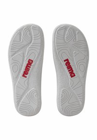 White shoe insoles with textured surface and contour patterns; features red "reima" logo prominently on the side.