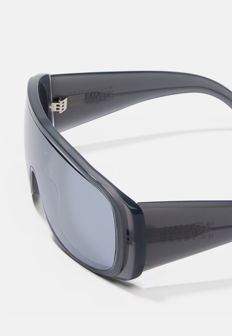 Sunglasses with dark gray, glossy plastic frame and lenses. Features a slight wraparound design and measurement markings on the temple.