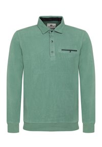 Vihreä puuvillainen pitkähihainen polo, jossa on kauluspaita, kolmesta nappista koostuva napitus ja rintatasku, jossa on musta yksityiskohta.