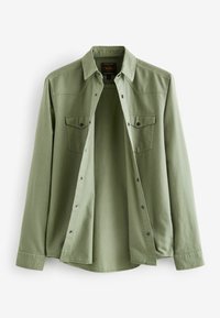 Light green button-up shirt featuring a collar, two chest pockets, and long sleeves with cuff buttons. Made of soft fabric with a smooth texture.