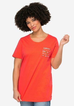 Bright red cotton T-shirt with a round neckline, short sleeves, and a decorative pocket featuring multicolored gems and studs.