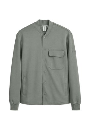 Chaqueta gris de manga larga con botones, con un bolsillo con solapa en el pecho, dos bolsillos laterales, puños acanalados y cuello sin solapa.