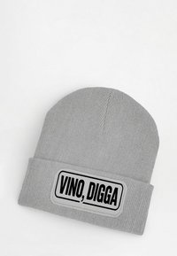 Gray beanie hat with a ribbed texture, featuring a rectangular patch with the text “VINO, DIGGA” in bold black lettering.