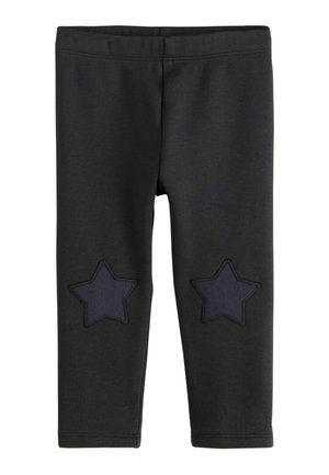 Sorte babyleggings med to mørke stjernemærker på knæene og elastik i taljen, vist forfra på hvid baggrund.