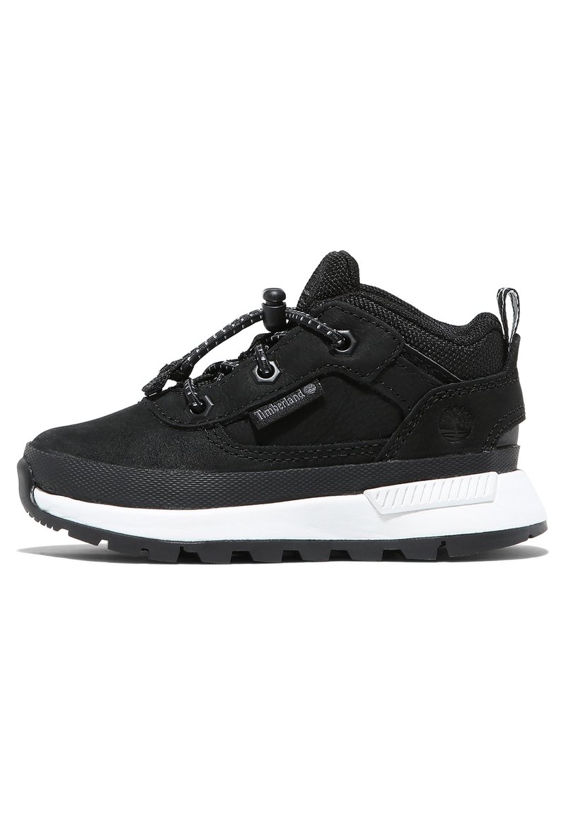 Black sneaker with a textured fabric upper, elastic laces, and a white midsole. Features a rugged sole and a small logo detail.