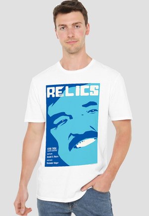 White t-shirt featuring a blue graphic design with the text "RELICS" and an illustration of a character's face. Simple, casual fit.