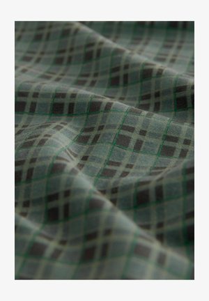 Grön, svart och grå rutig tyg med en mjuk textur; har ett rutmönster som är utmejslat i grönt med varierande rutor och rektanglar.