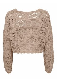 Kort stickad tröja i ljusbeige med hålmönster, långa ärmar och vågig nederkant. Den texturerade designen ger visuell charm.