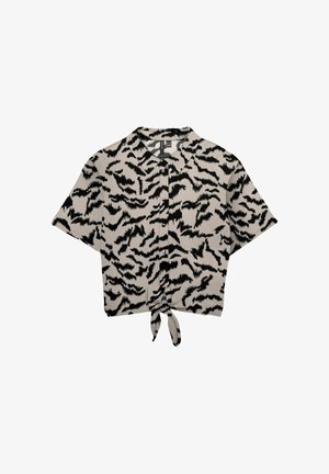 Chemise beige à manches courtes avec boutons, imprimé animalier abstrait noir et nœud à l'avant.