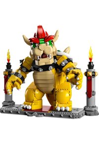 LEGO Bowser figure with yellow body, green and red accents, spiked shell, menacing face, and flame-topped pillars on a gray base.