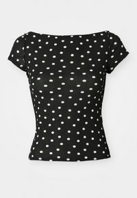 Black short-sleeve top with white polka dots. Features a boat neckline and fitted waist, made from a soft, lightweight fabric.