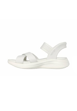 White open-toe sandal with crisscross fabric straps, padded sole, and elastic back strap against a white background.