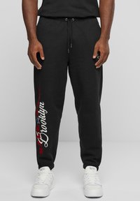 Karl Kani - SMALL SIGNATURE PATCHED CUFFED - Tracksuit bottoms - black Thumbnail Image 1