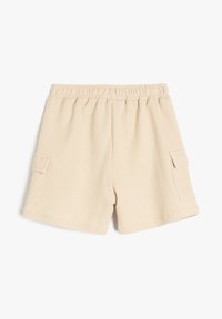 Beige strukturerede strikkede shorts med elastisk talje og cargo-lommer på begge sider, lagt fladt på hvid baggrund.