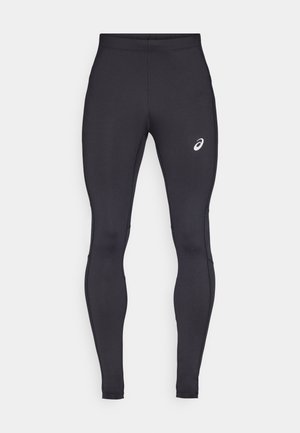 Leggings de sport noirs en tissu extensible et lisse. Présentent un design ajusté et un petit logo blanc en haut de la cuisse gauche.