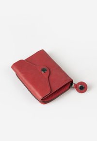 Red leather wallet with a zip closure, smooth texture, snap button detail, and rounded shape. Compact design suitable for cards and coins.