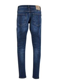 Tamsiai mėlyni džinsai siauru kirpimu, su vidutinio aukščio liemeniu, dviem galinėmis kišenėmis ir odos skiriamuoju ženklu ant juosmens.