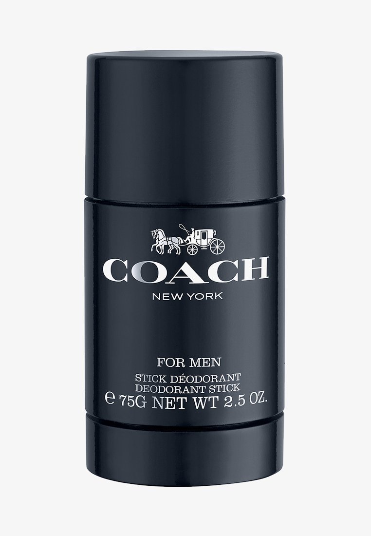 Svart cylindrisk stick-deodorant med silvertext. Innehåller "COACH NEW YORK", "FÖR MÄN" och produktinformation i kontrasterande färger.
