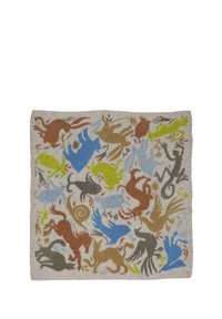 Woven wool tapestry featuring various animal silhouettes in earthy tones, blue, green, and beige on a neutral background.